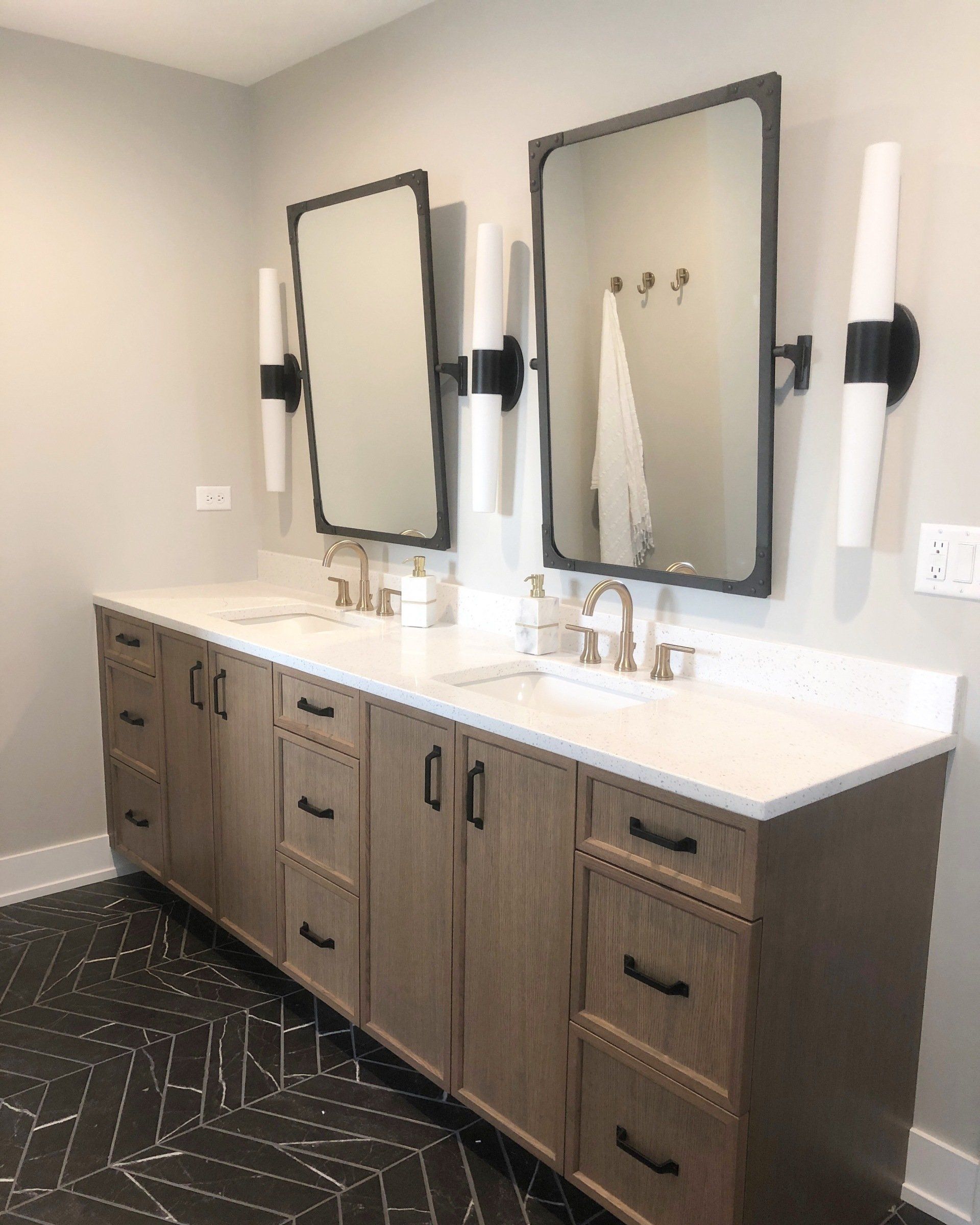 A bathroom with two sinks and two mirrors.
