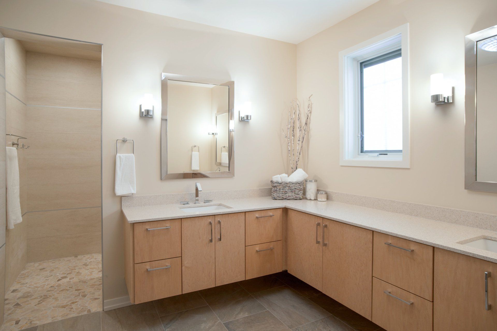 A bathroom with two sinks , a mirror and a window