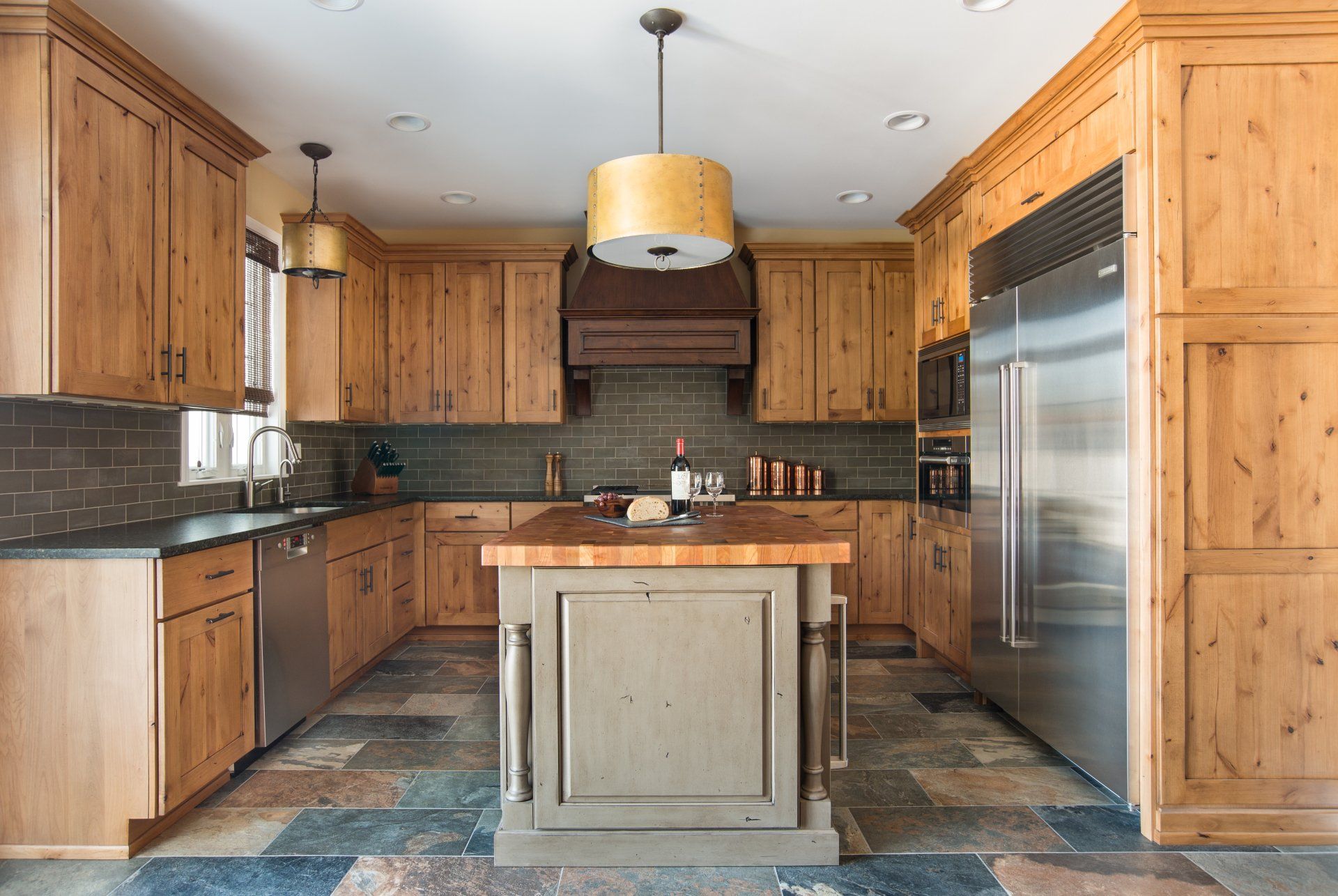 A kitchen with wooden cabinets and stainless steel appliances