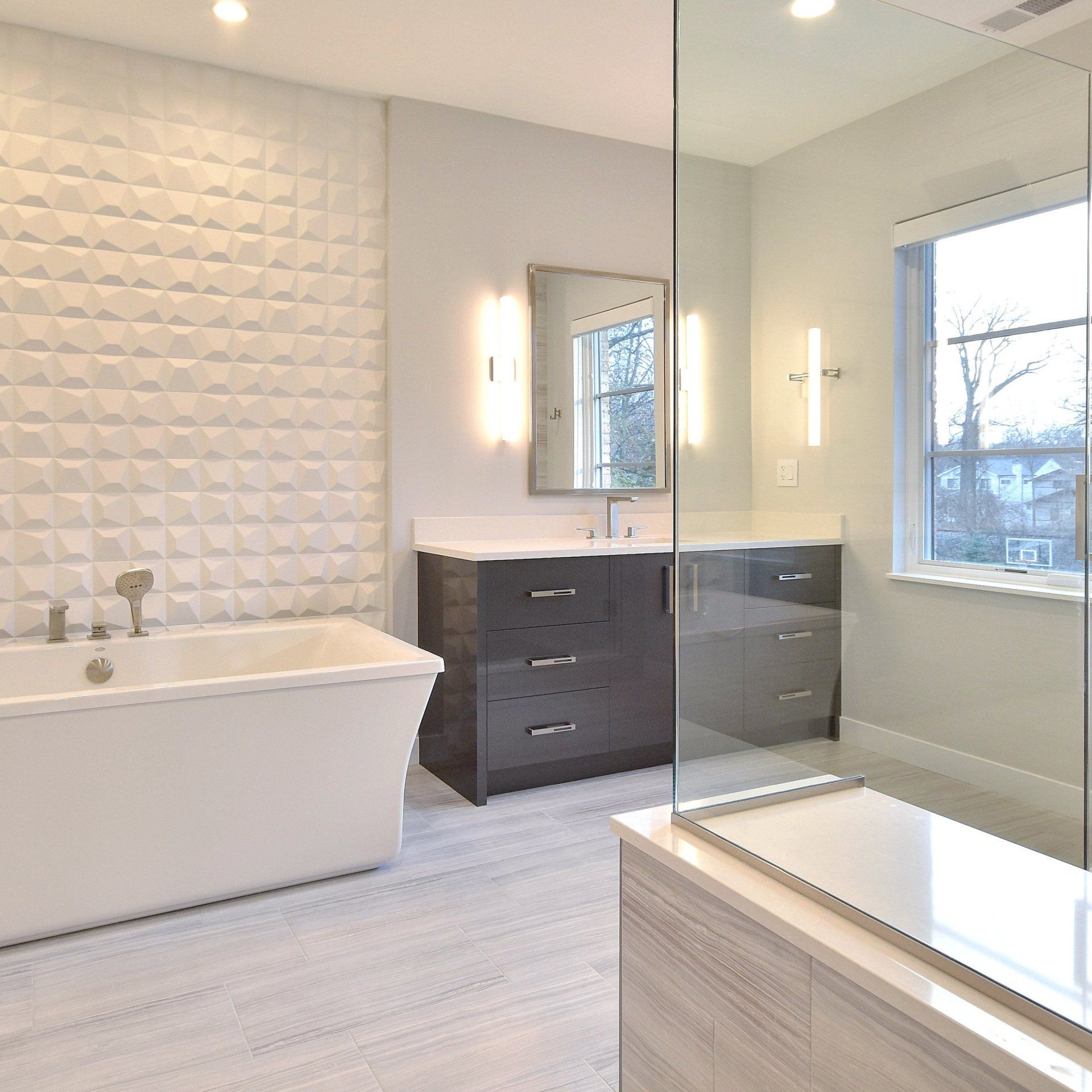A bathroom with a tub a sink and a mirror