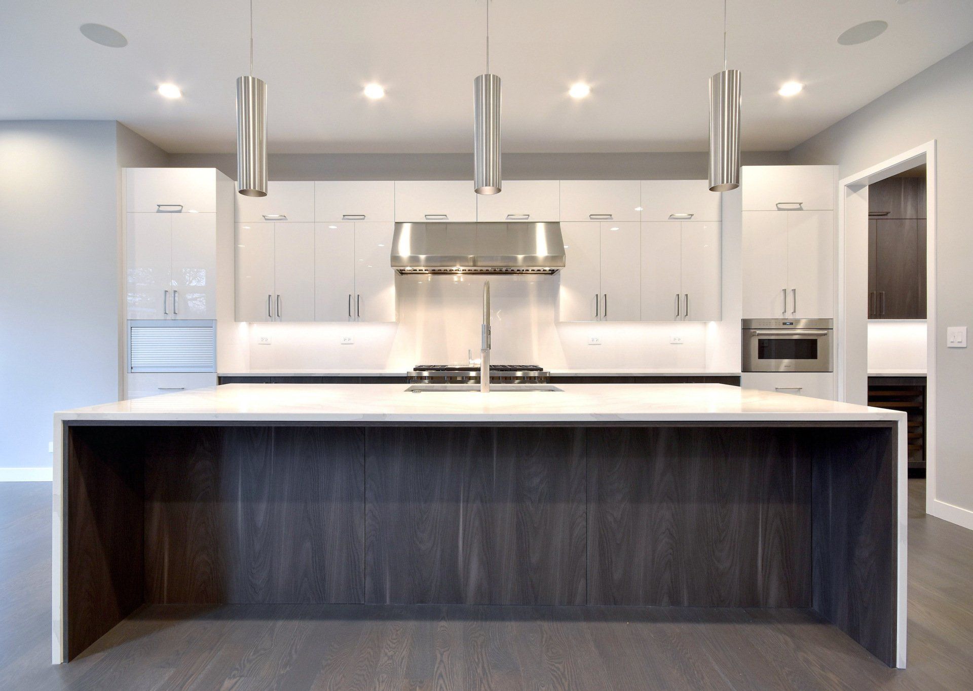 A kitchen with a large island and stainless steel appliances