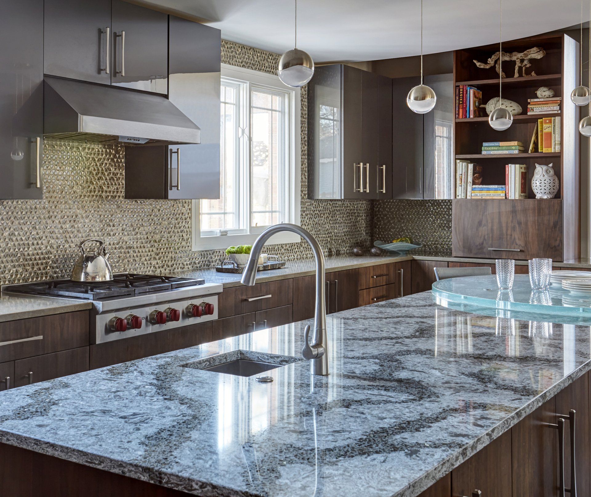 A kitchen with granite counter tops and a stove top oven