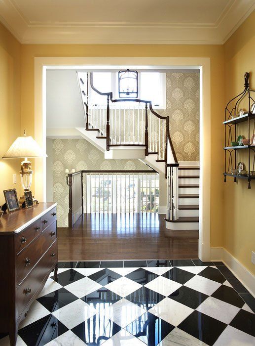 A black and white checkered floor with a staircase in the background