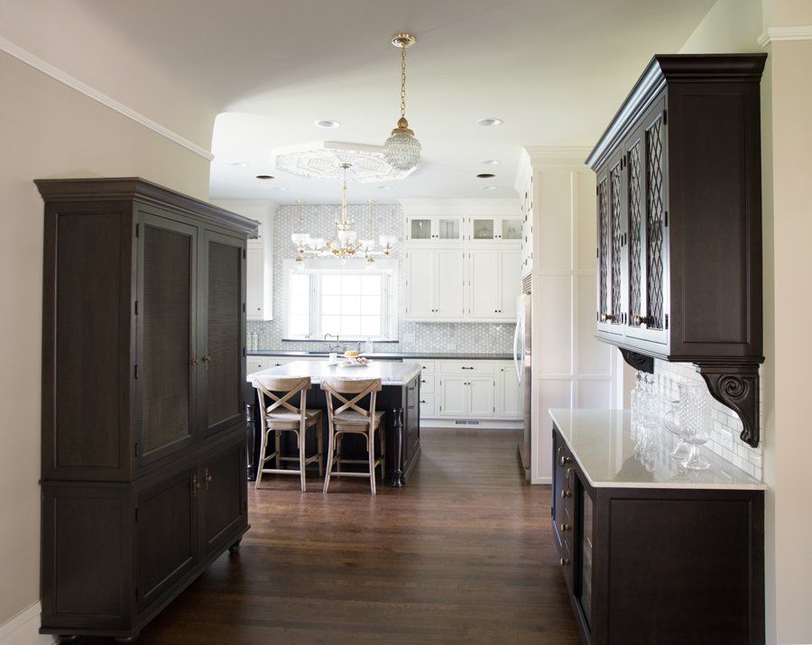 A kitchen with black cabinets and white cabinets