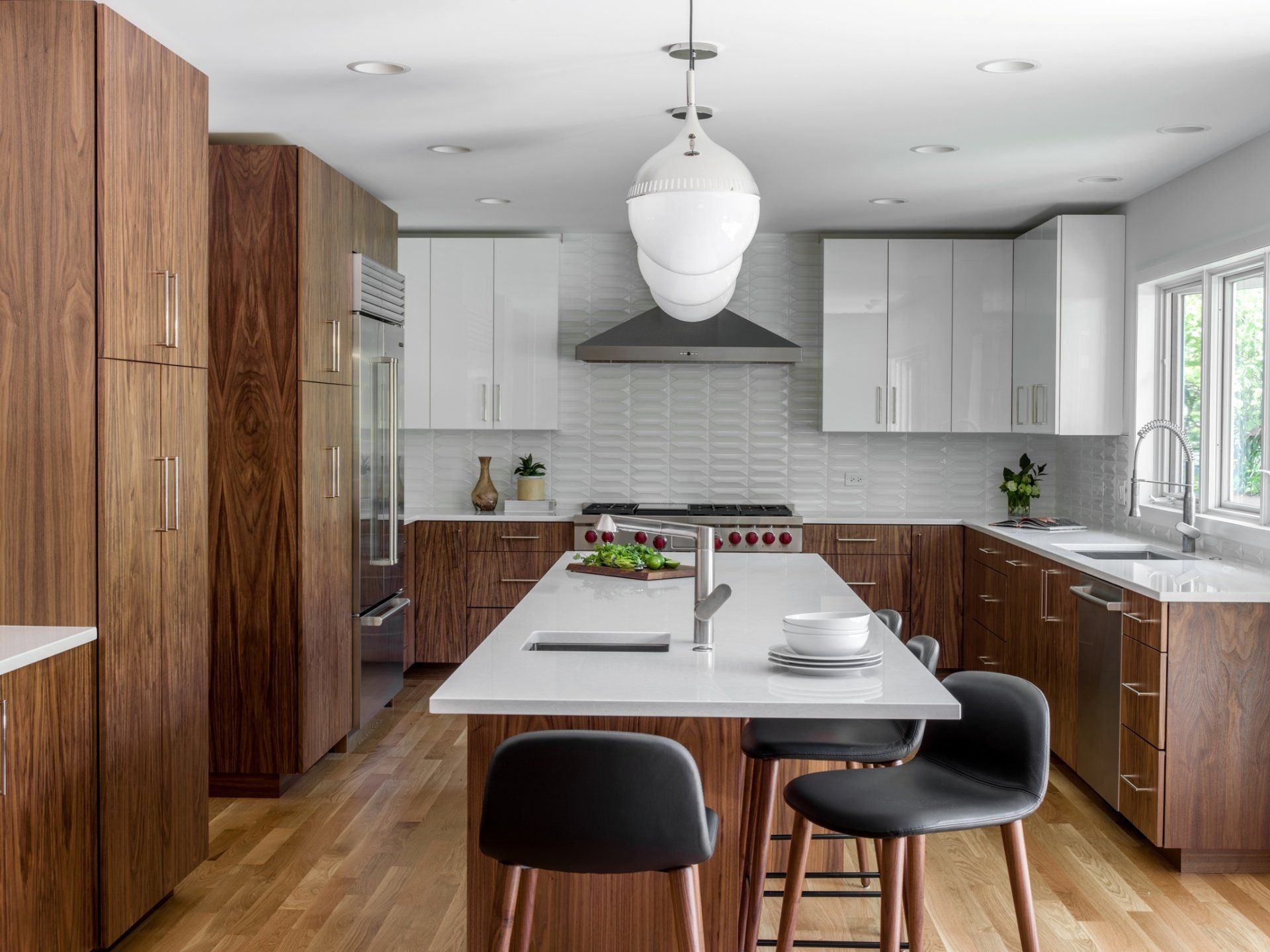A kitchen with wooden cabinets , white counter tops , and a large island.