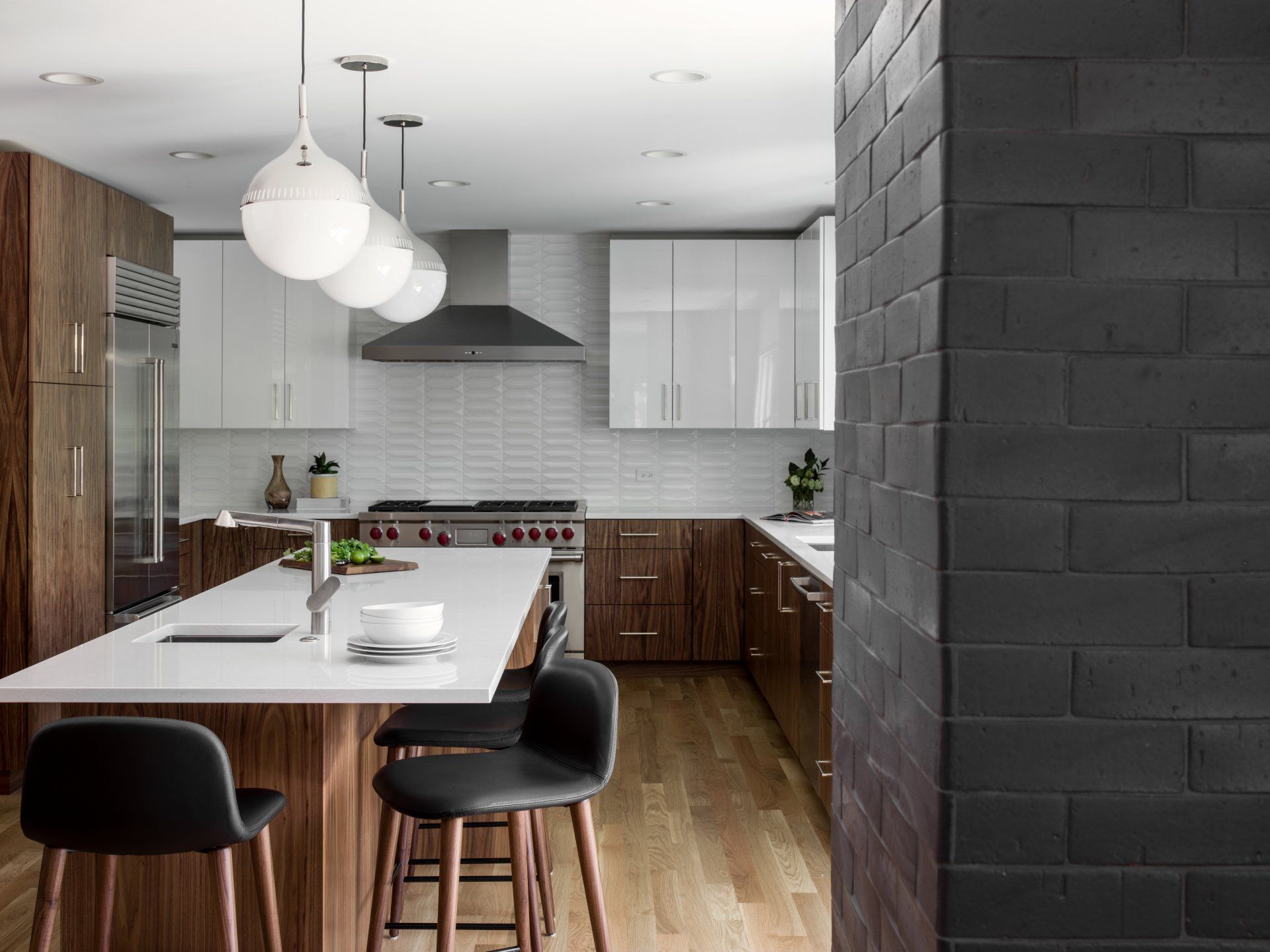 A kitchen with a large island and stools
