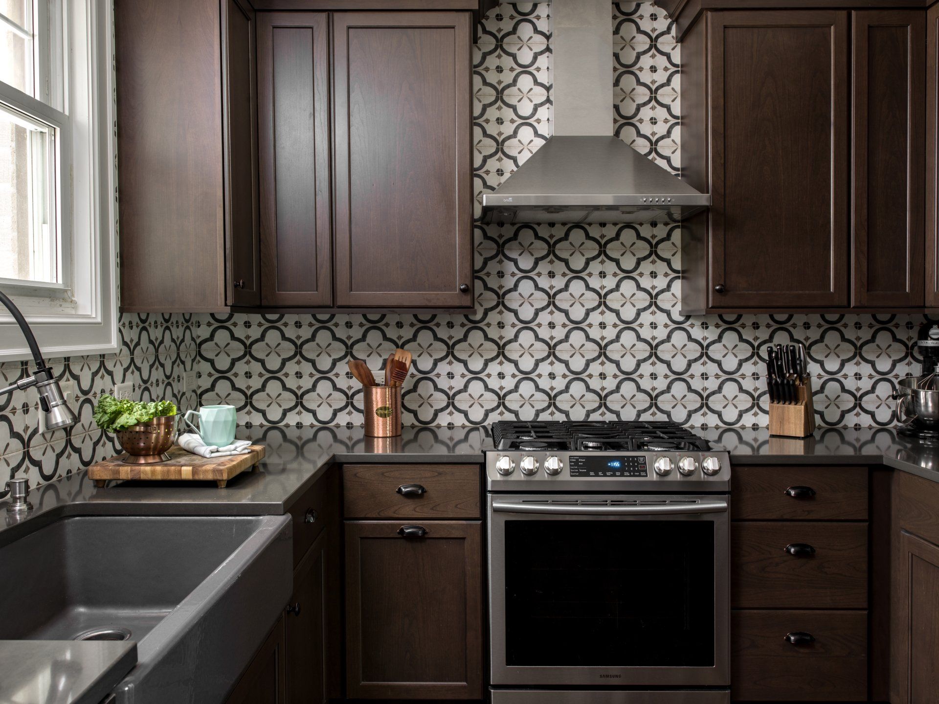 A kitchen with stainless steel appliances and wooden cabinets