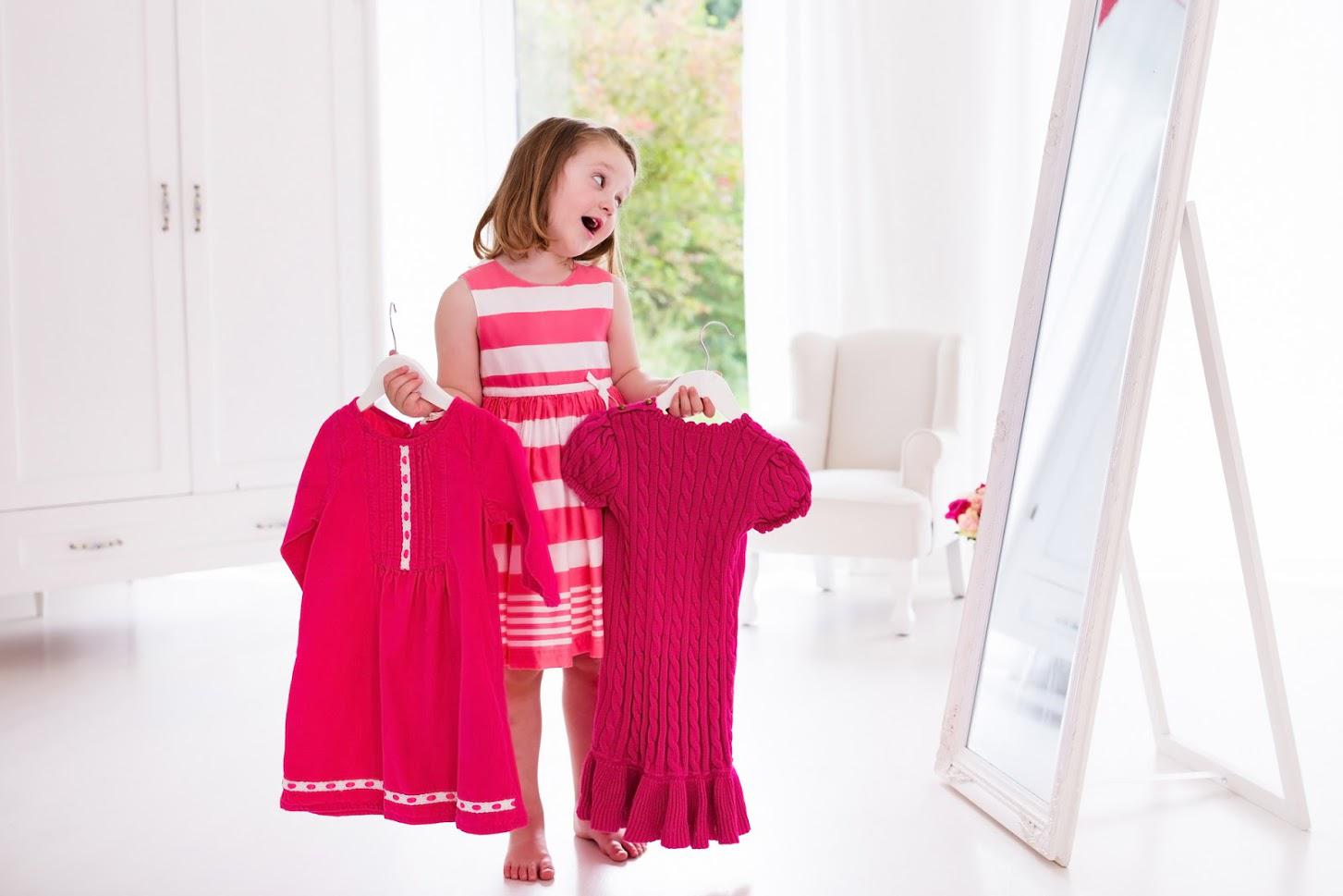 Packing — Child Holding Two Pink Dresses in Vienna, VA Packing — Child Holding Two Pink Dresses in Vienna, VA