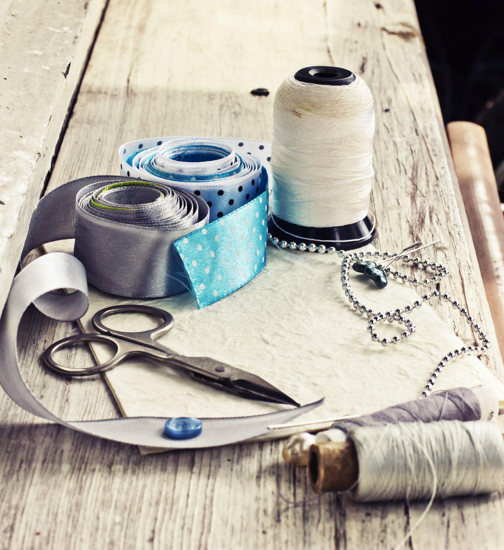 Spools of thread and scissors on a wooden table