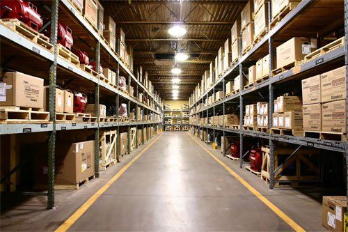 A large warehouse filled with lots of boxes on shelves