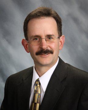 Attorneys — Lawyer Writing On Legal Documents At Desk in Elkhart, IN Attorneys — Lawyer Writing On Legal Documents At Desk in Elkhart, IN