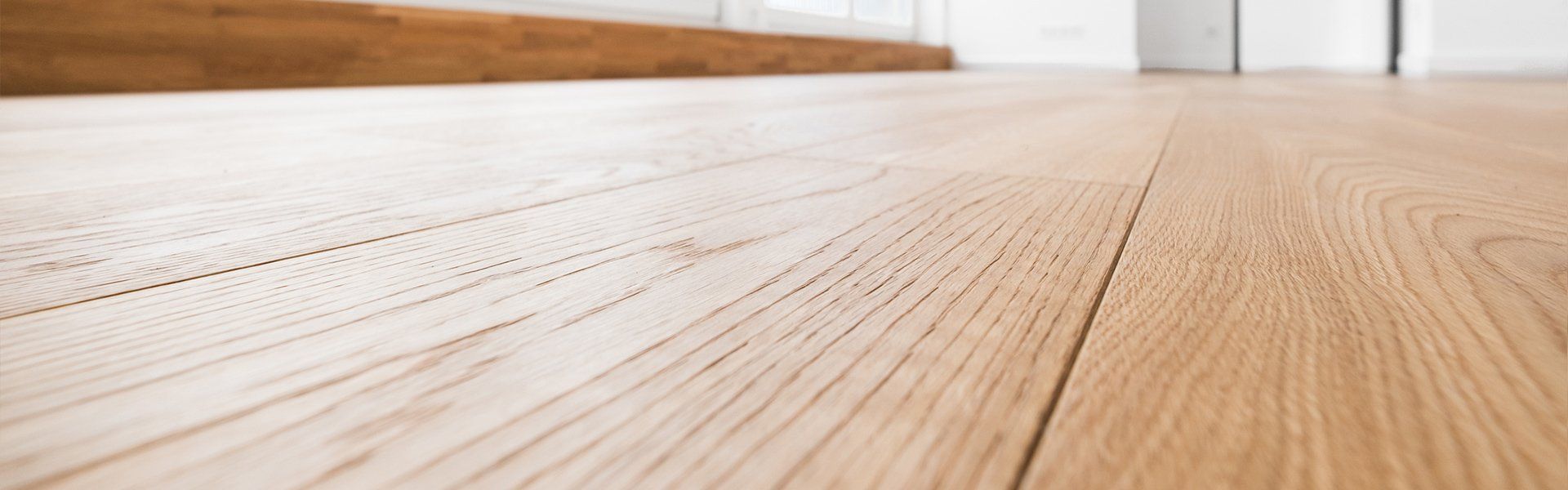 A close up of a wooden floor in an empty room.