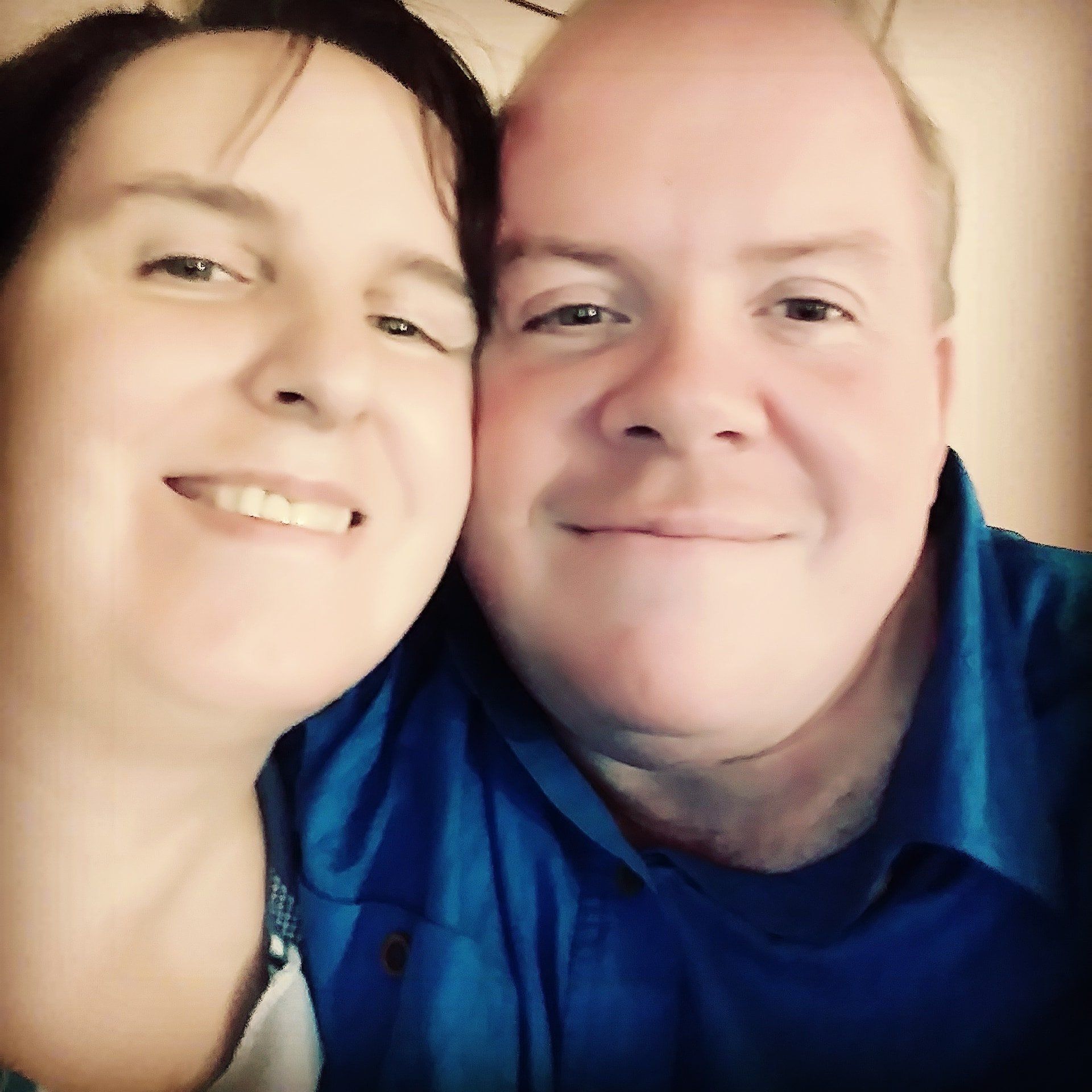 A man and a woman are posing for a picture together