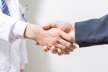Civil law — Doctor and lawyer shaking hands in Brighton, CO