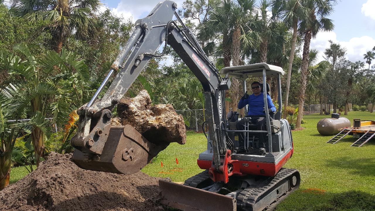 Man Operating Excavator — Naples, FL — First Class Plumbing of Florida, Inc.