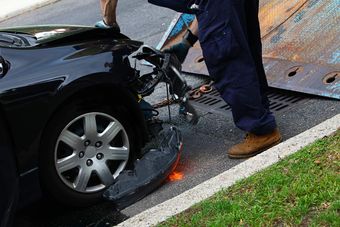 damaged car being towed