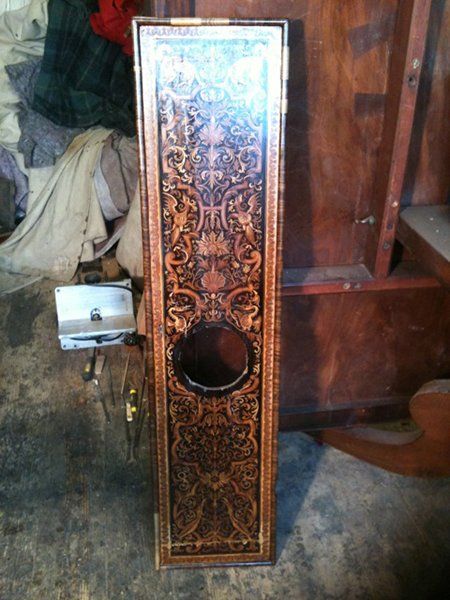 A clock door being repaired