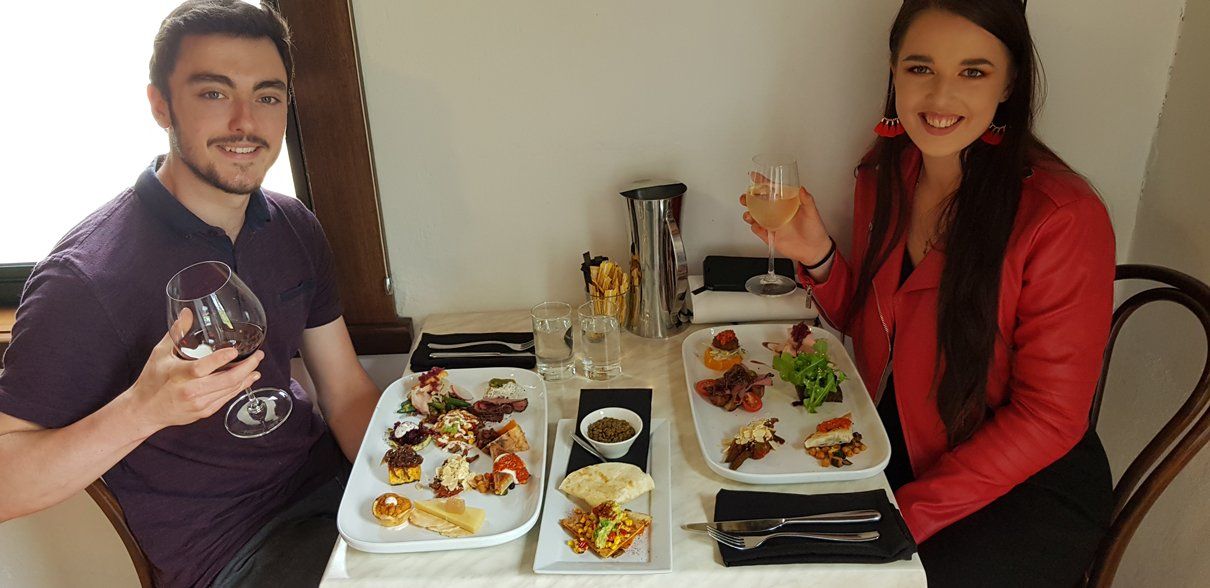 couple eating with wine