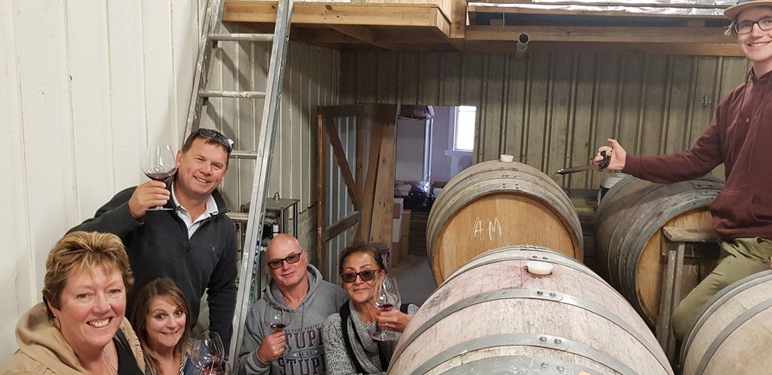 3 woman and 3 guys in wine storage