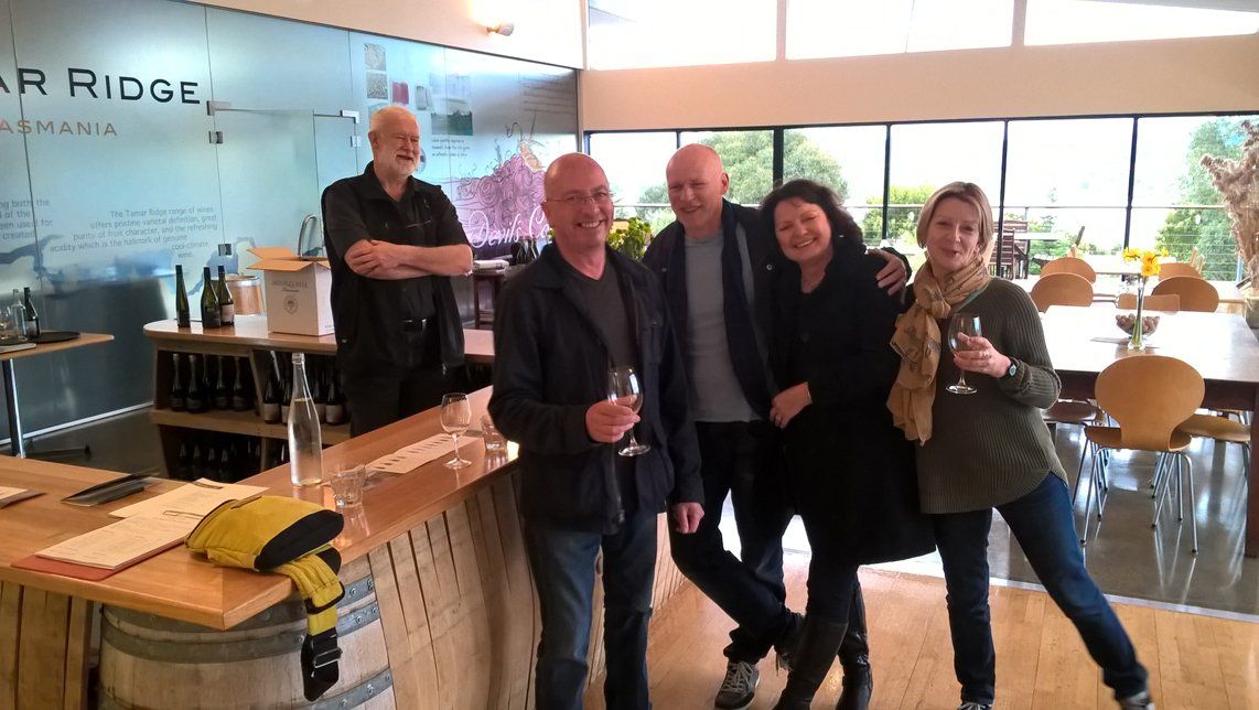 Three guys and two women enjoying a wine tour.