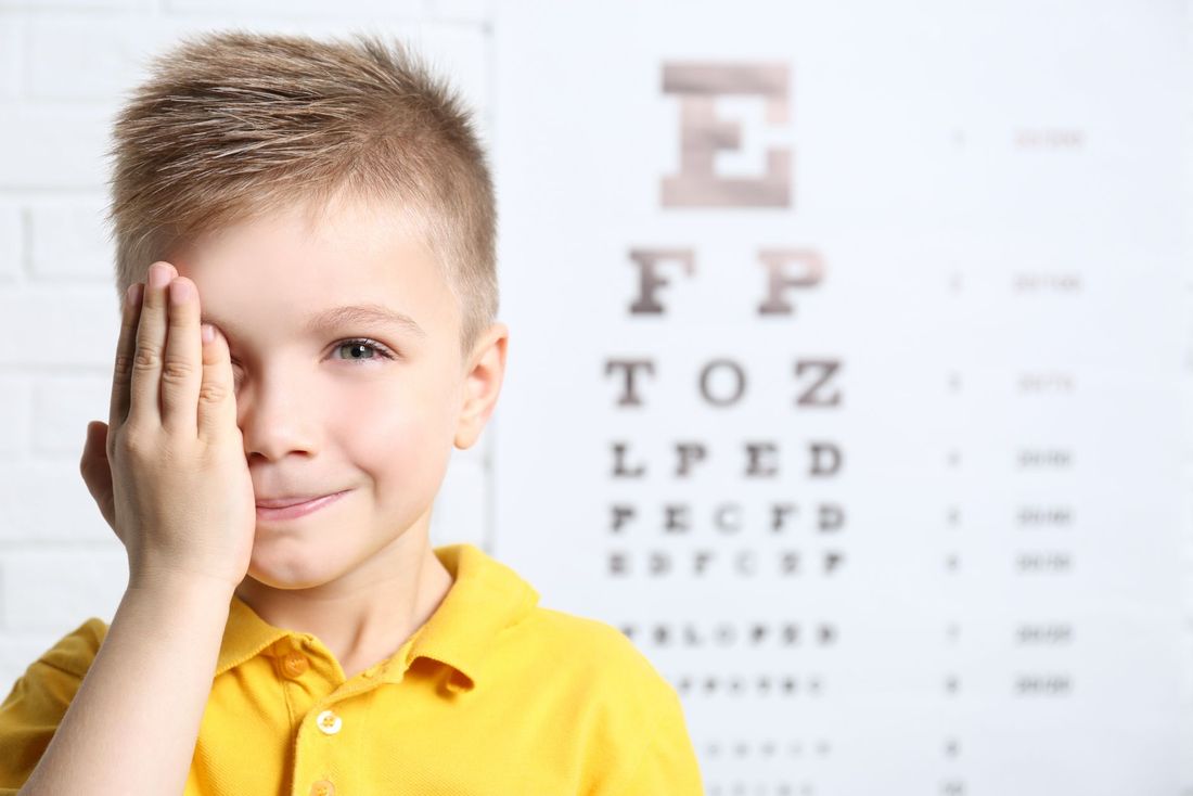 un bambino che legge la tavola optometrica