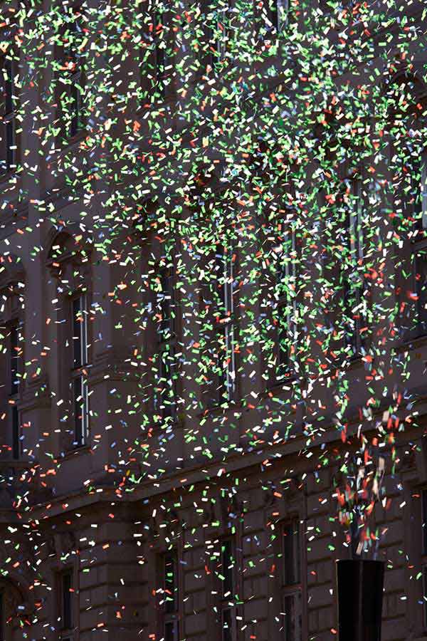 cannon shooting multi-coloured confetti into the street