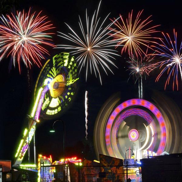 kc's fireworks fair and festival fireworks display over fair ground rides