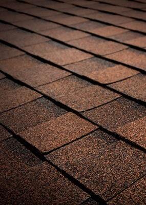 A close up of a brown roof with shingles.