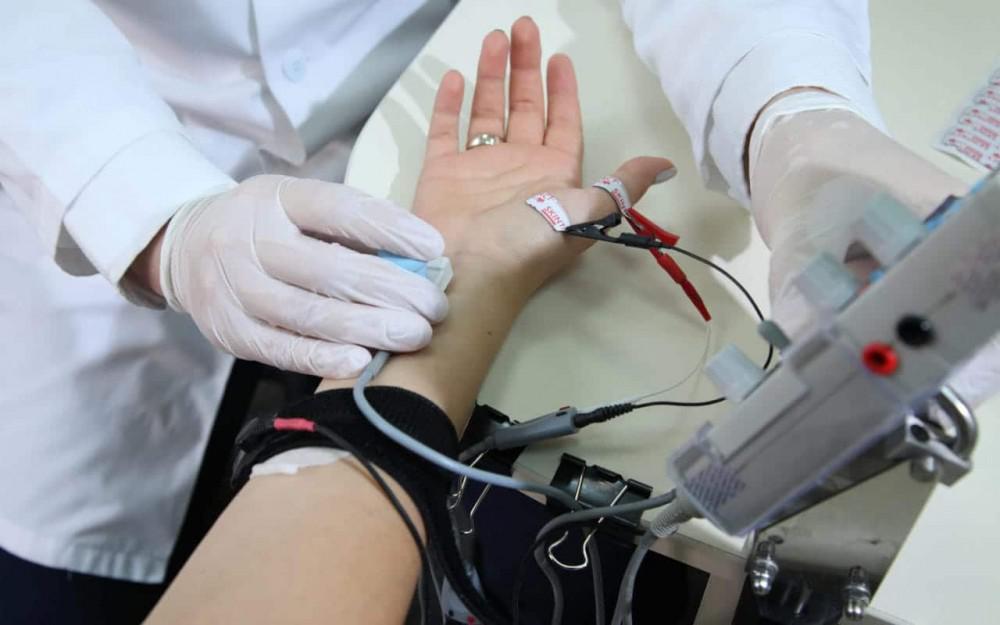 doctor performs EMG test for carpal tunnel