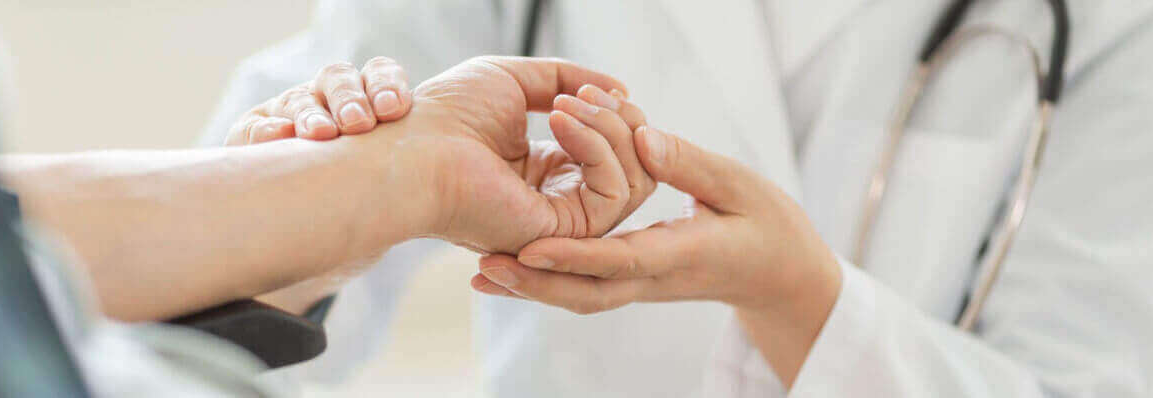 doctor examines hand