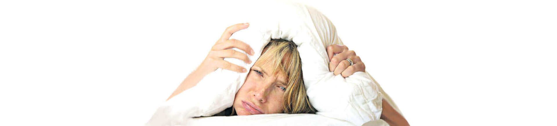 wman covering her head with a pillow