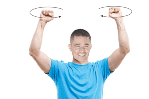 man twirling his hands over his head