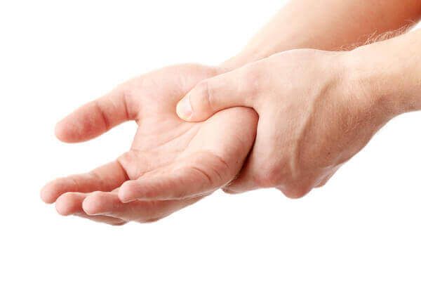 hand squeezing opposite hand due to pain