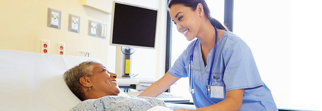 doctor helps patient in recovery room