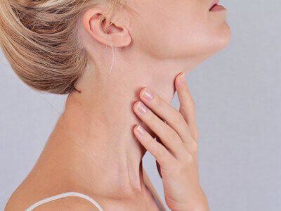 woman touching her neck