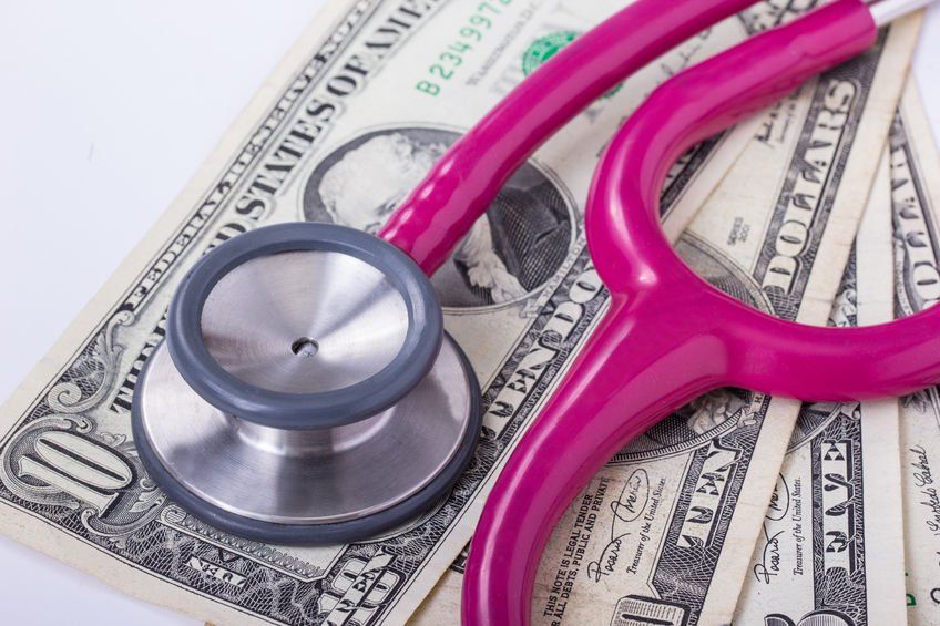 stethoscope on top of dollars