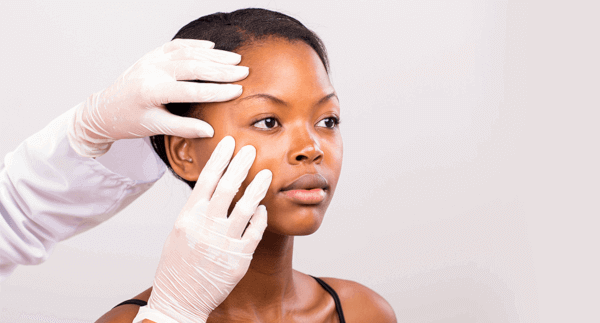 doctor examining face skin lightening