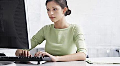 woman typing at a desk