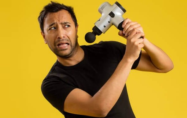man struggling with a vibration massager