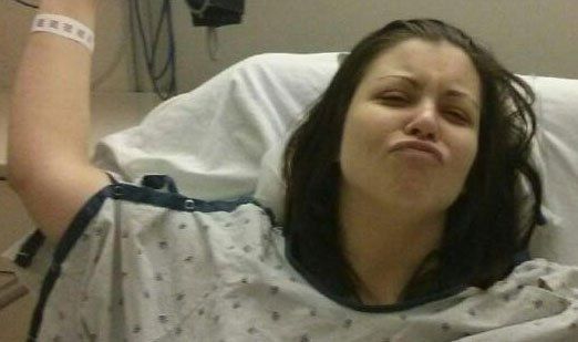 Young caucasiion woman wakes up after carpal tunnel surgery.