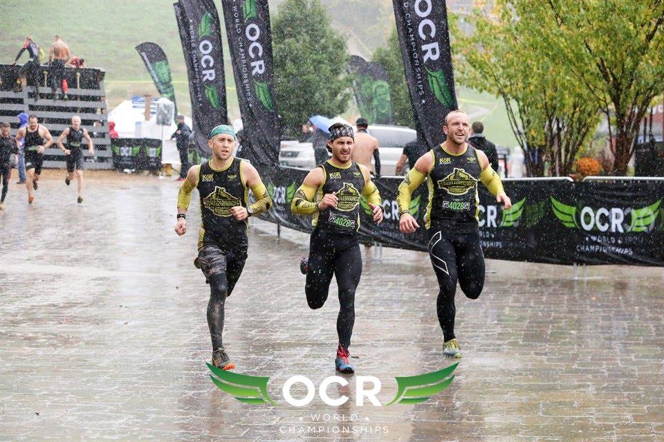 A group of men are running in the rain.