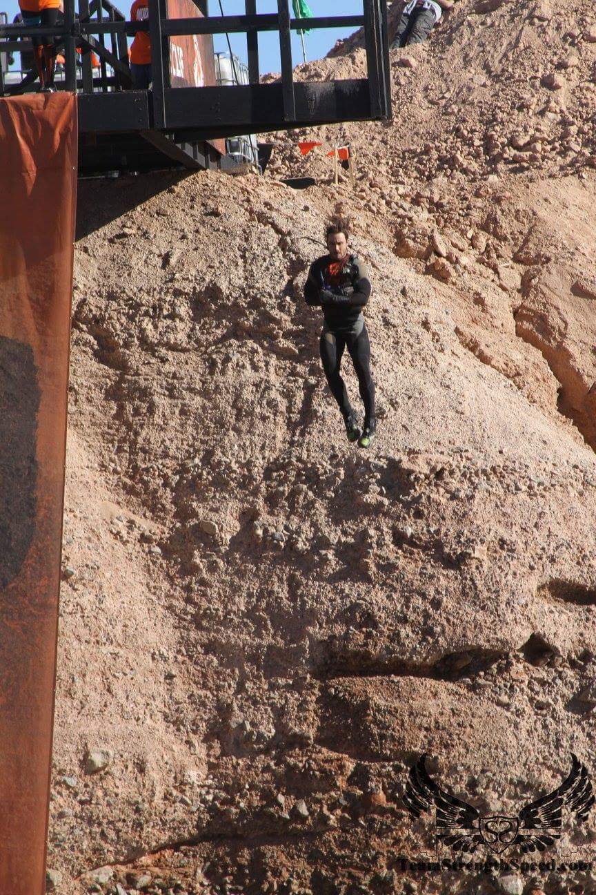 A person is climbing up a rocky hill