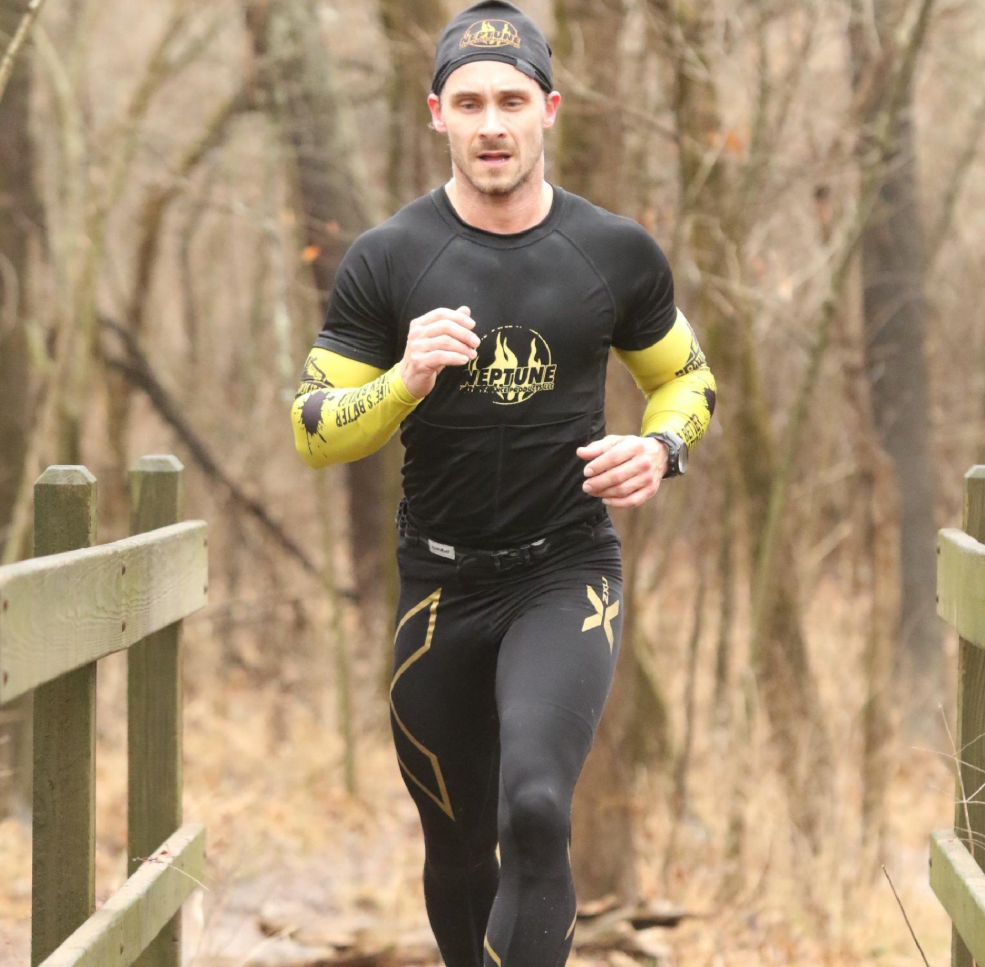 A man wearing a black shirt that says marathon on it