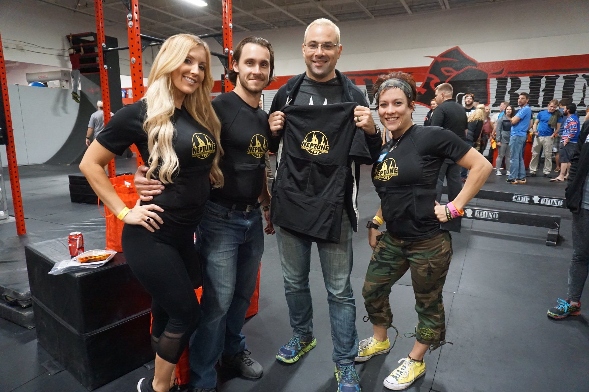 A group of people are posing for a picture in a gym.