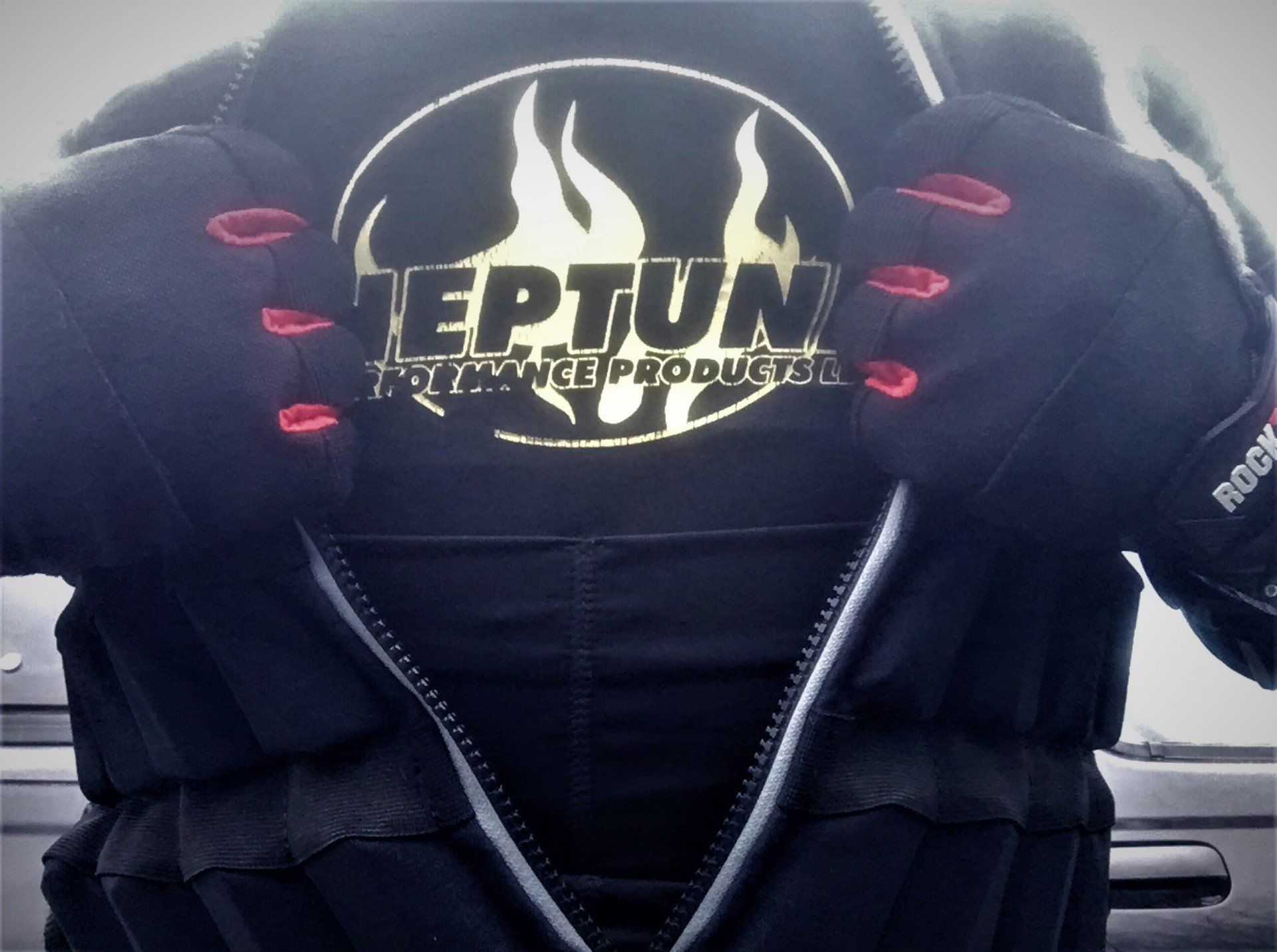 A person wearing a black jacket with the word teptun on it