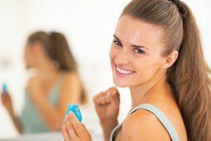 woman about to floss her teeth, dental trivia fun: know your tools blog