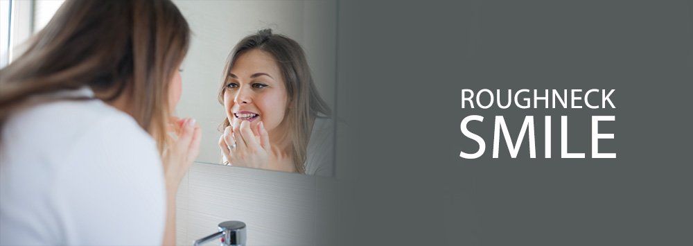 woman looking at her teeth on the mirror, roughneck smile blog