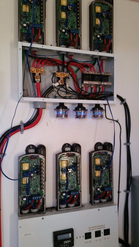 A wall with a bunch of wires coming out of it