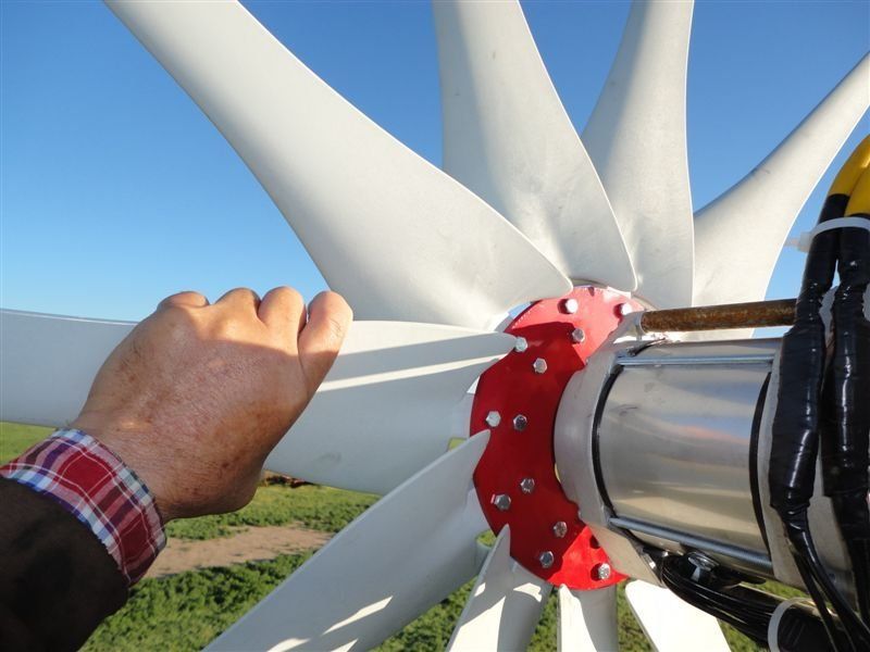 A close up of a person 's hand on a wind turbine