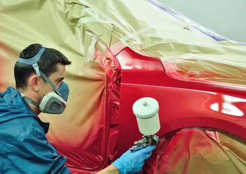 Auto body expert repainting the auto body — Port Allen, LA — Delaune’s Auto Body Auto body expert repainting the auto body — Port Allen, LA — Delaune’s Auto Body